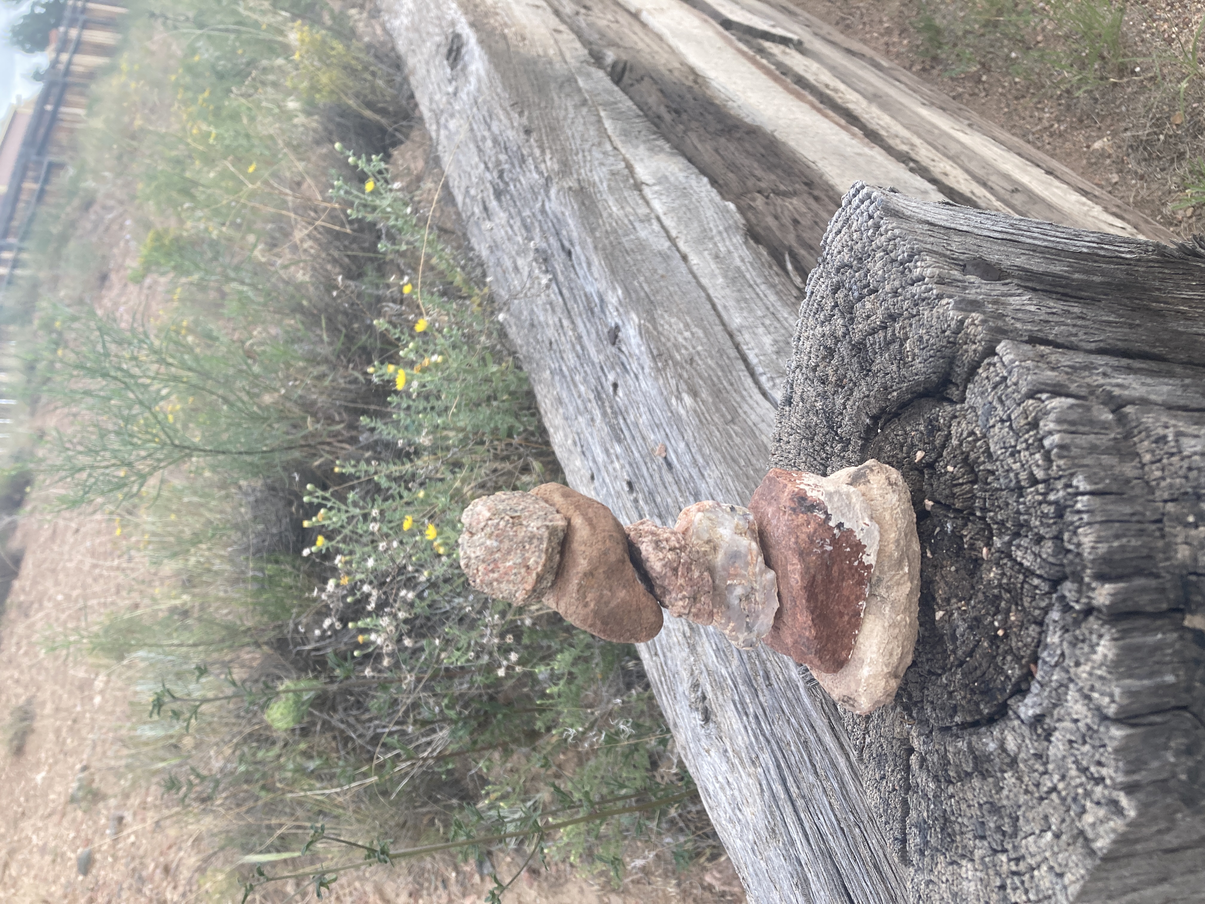 Photo of a small cairn made of pebbles, stacked vertically in a not impressive way